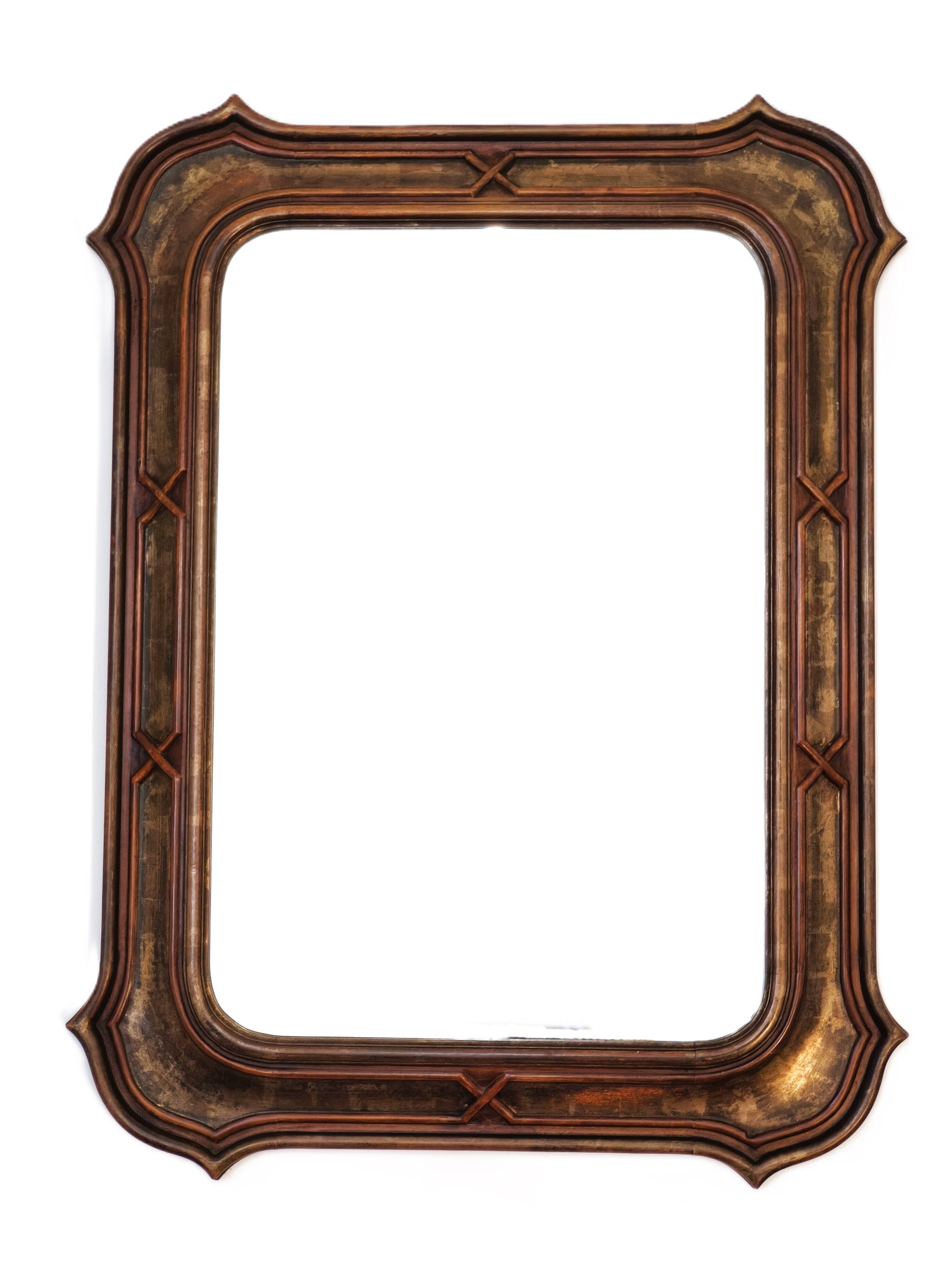 Italian sculpted mirror, patinated brown and gold wood, architectural frame from the 1960s.