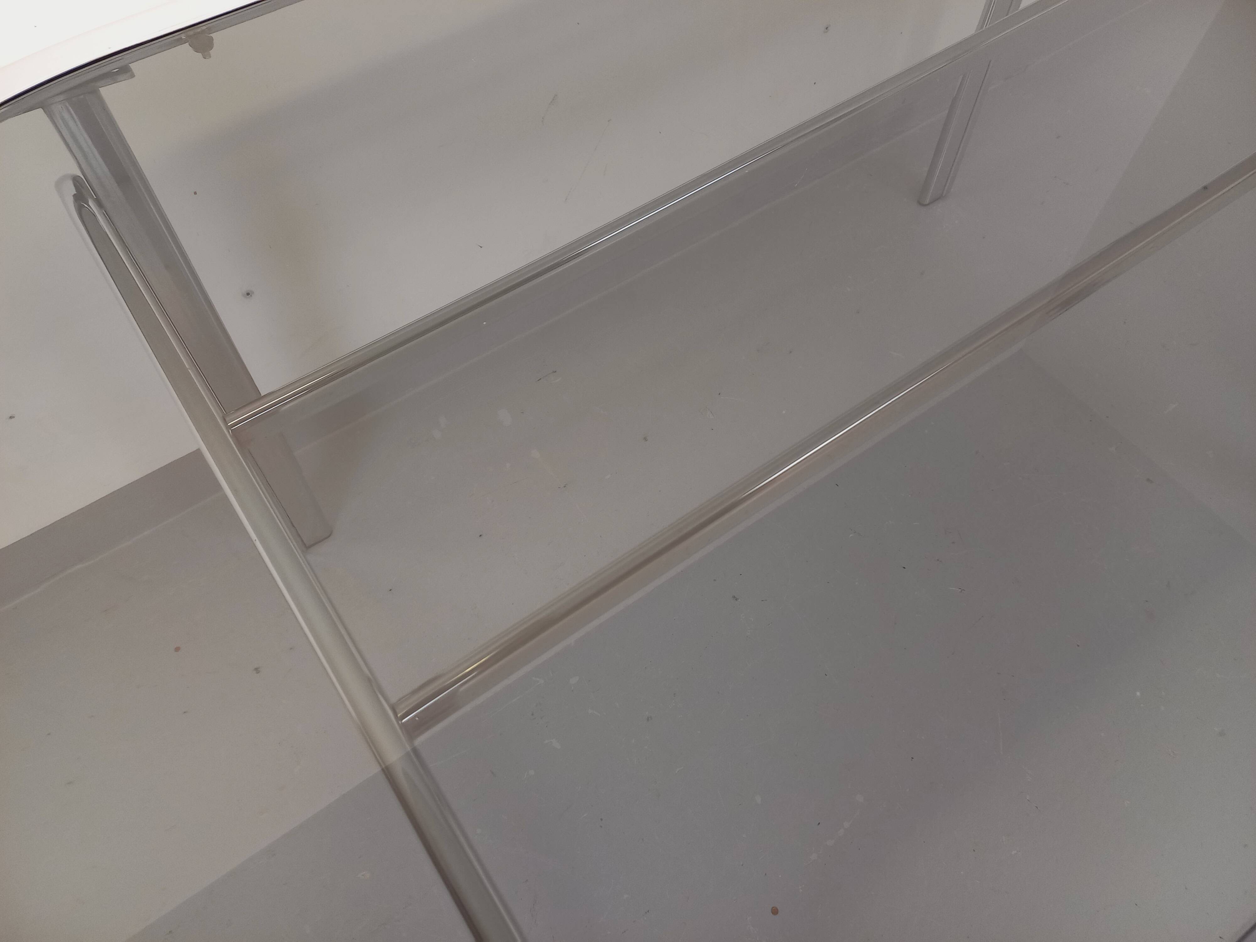 Vintage oval dining table in smoked glass and chrome metal, Space Age style.