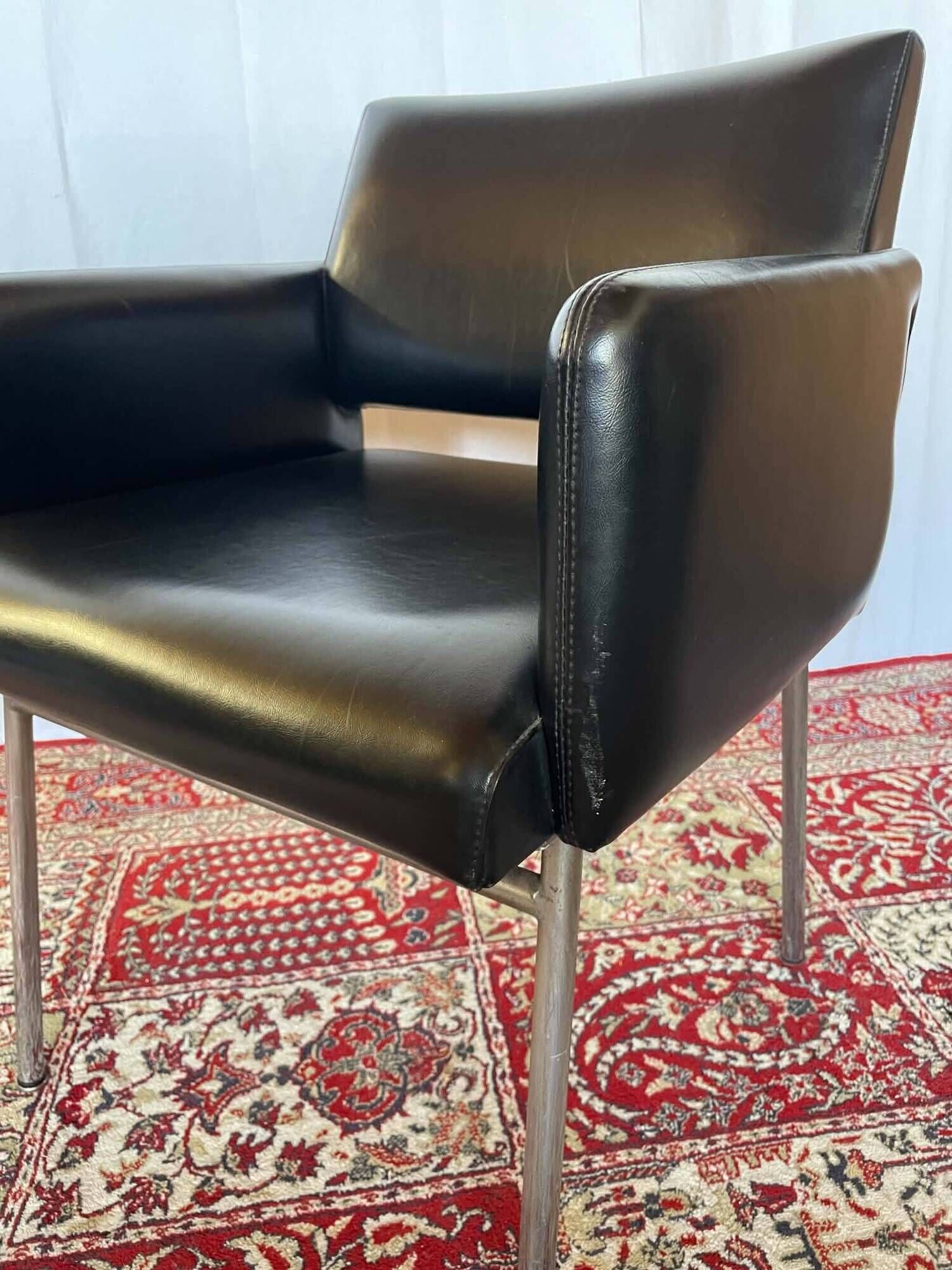 Pair of vintage armchairs in black faux leather and chrome metal.