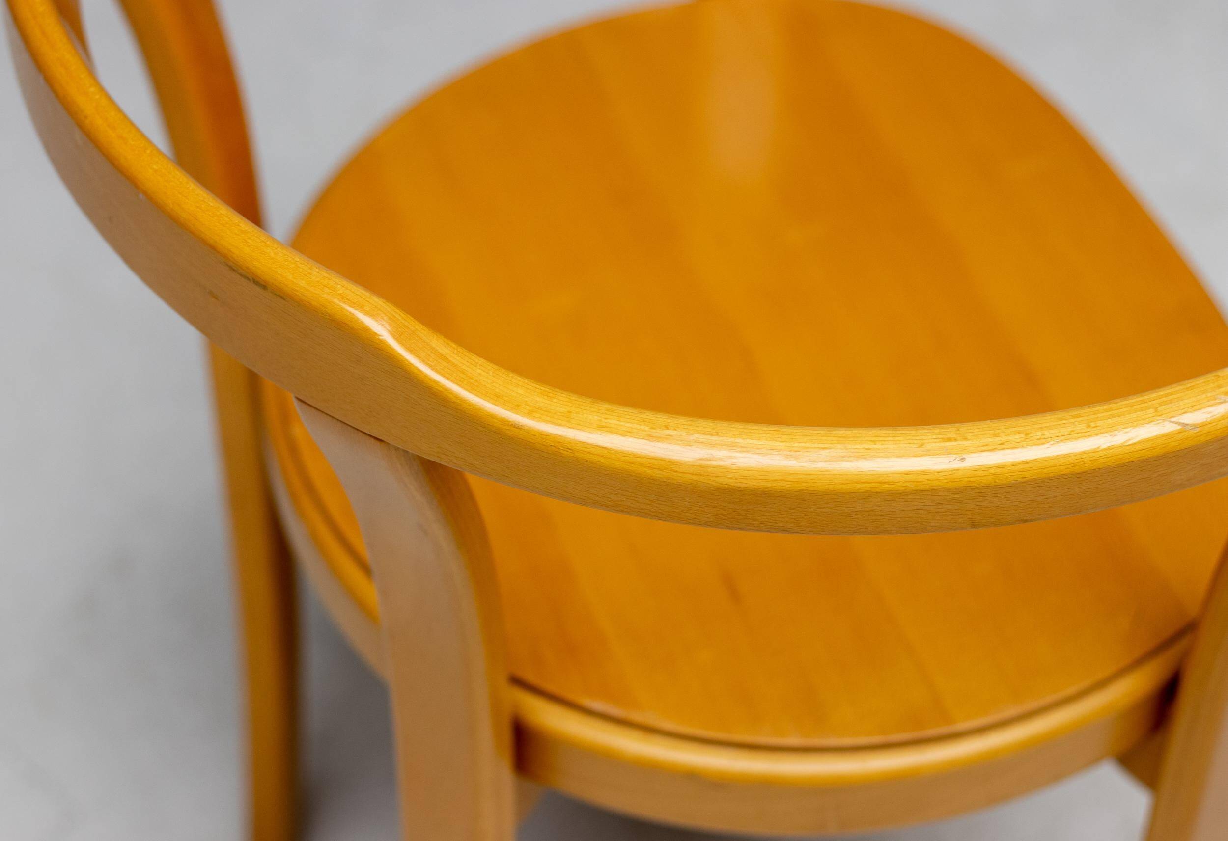 Stackable chairs in curved beech.