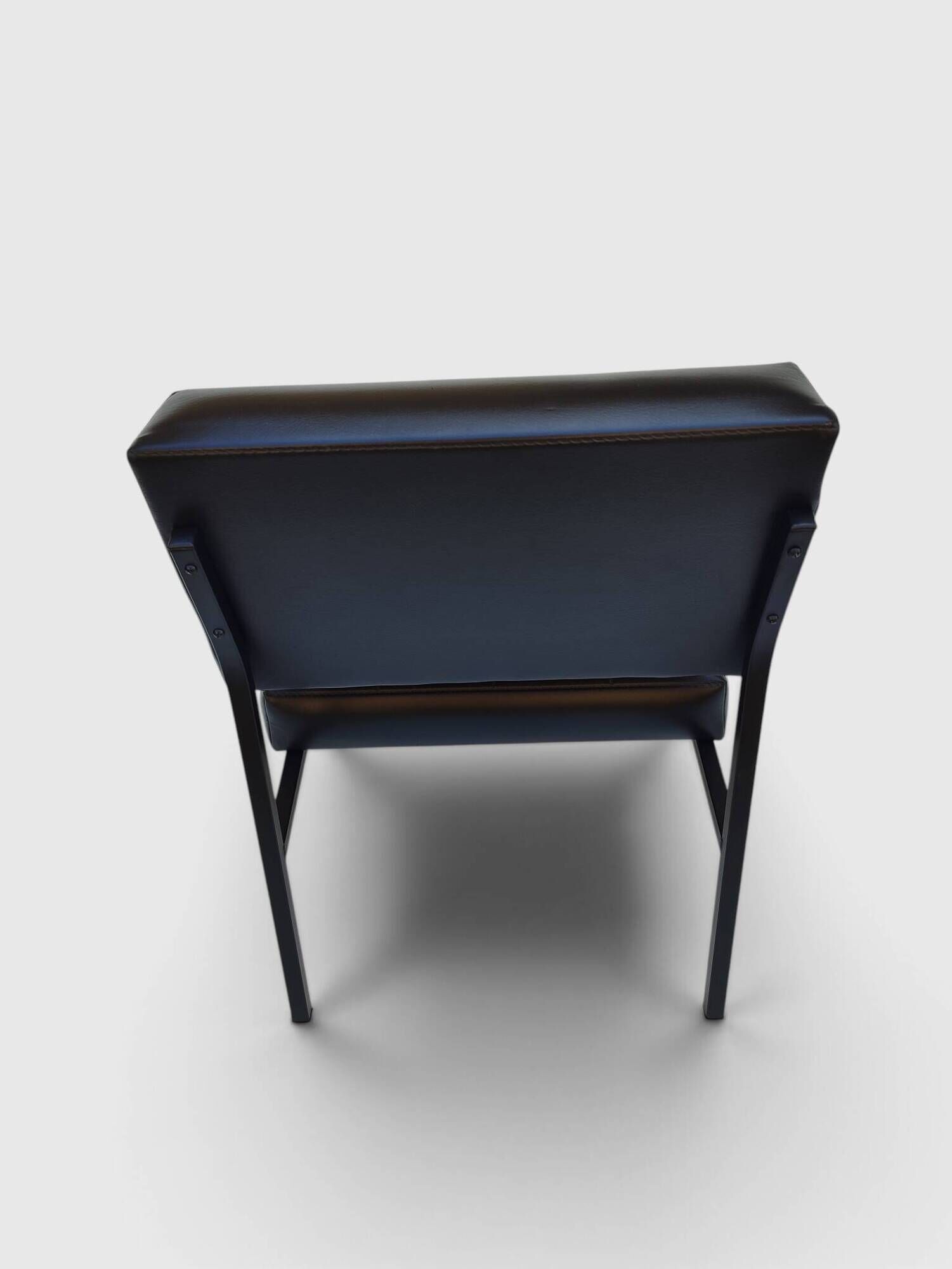 Modernist armchair in black faux leather and metal – 1960s