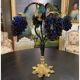 Table lamp with four light arms and globes shaped like bunches of grapes.