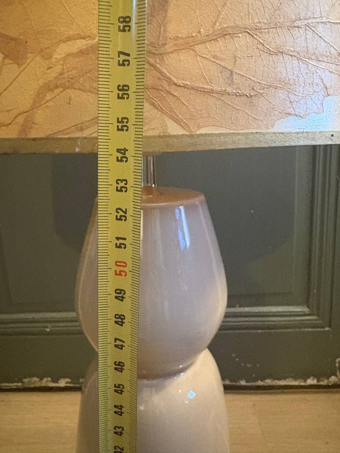 Large beige ceramic table lamp with a vintage shade.