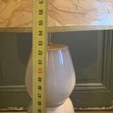 Large beige ceramic table lamp with a vintage shade.