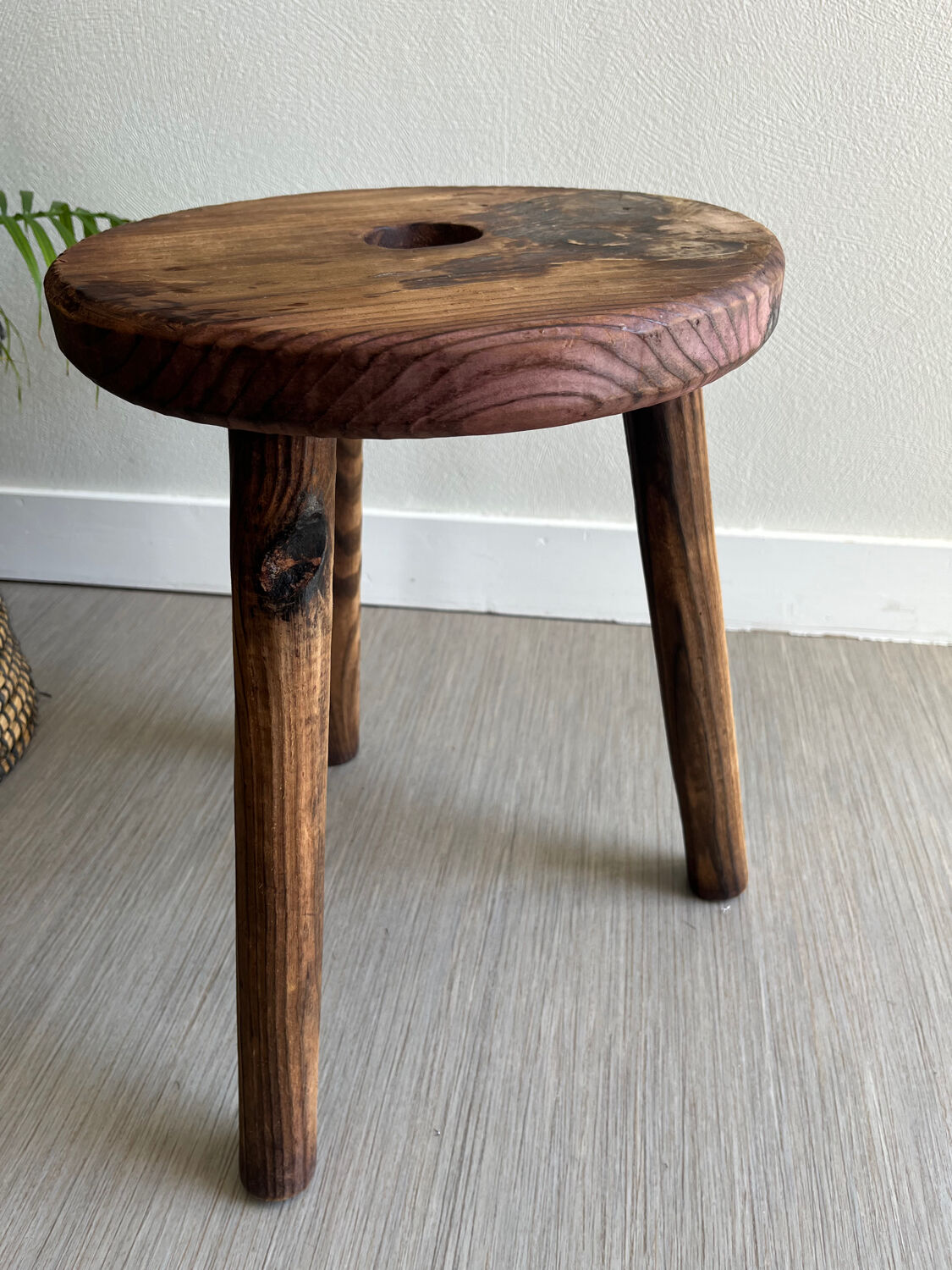 Three-legged wooden stool