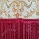 Beige toad armchair with floral patterns and red fringes