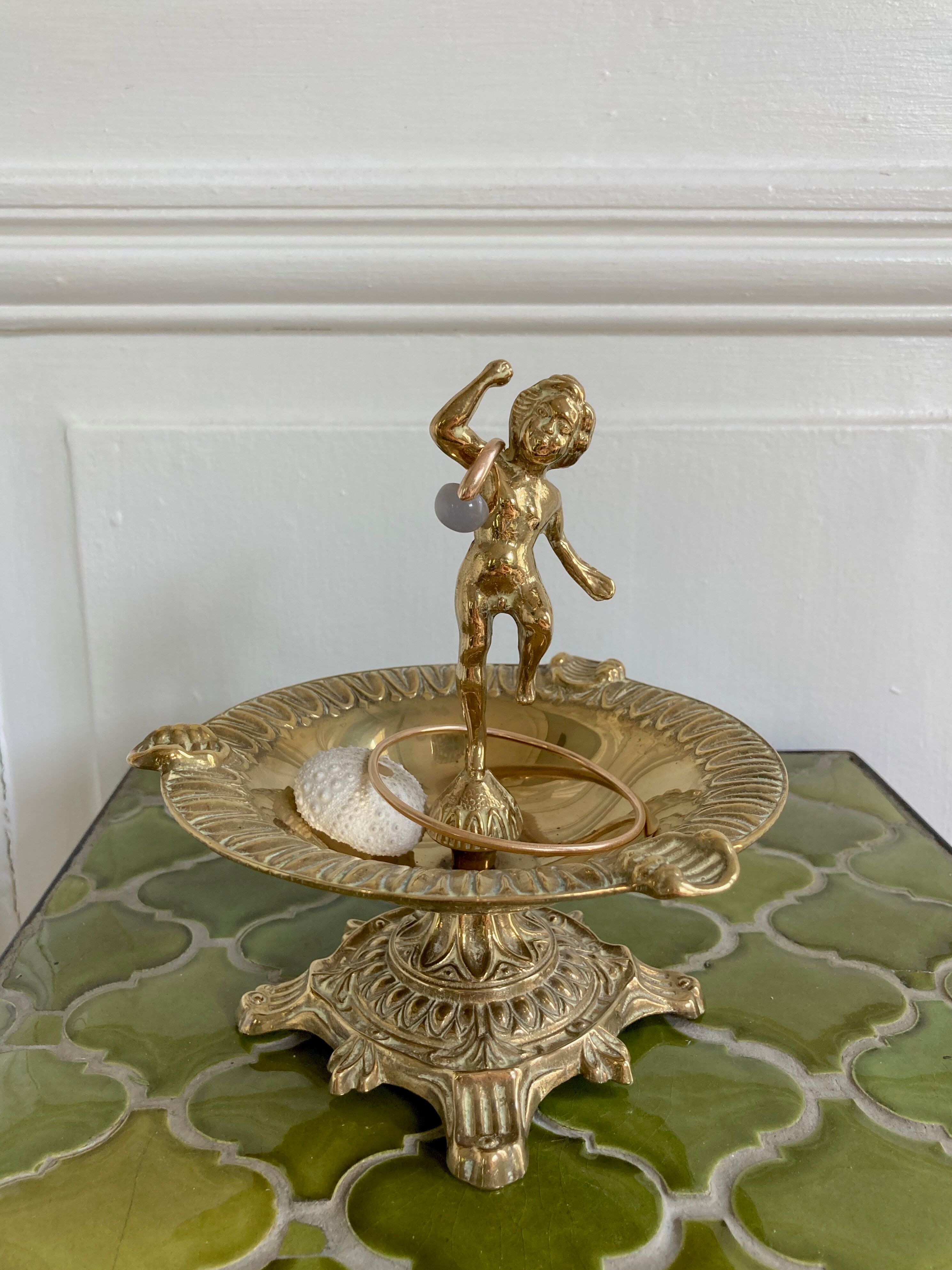 Brass cherub pocket-empty ashtray
