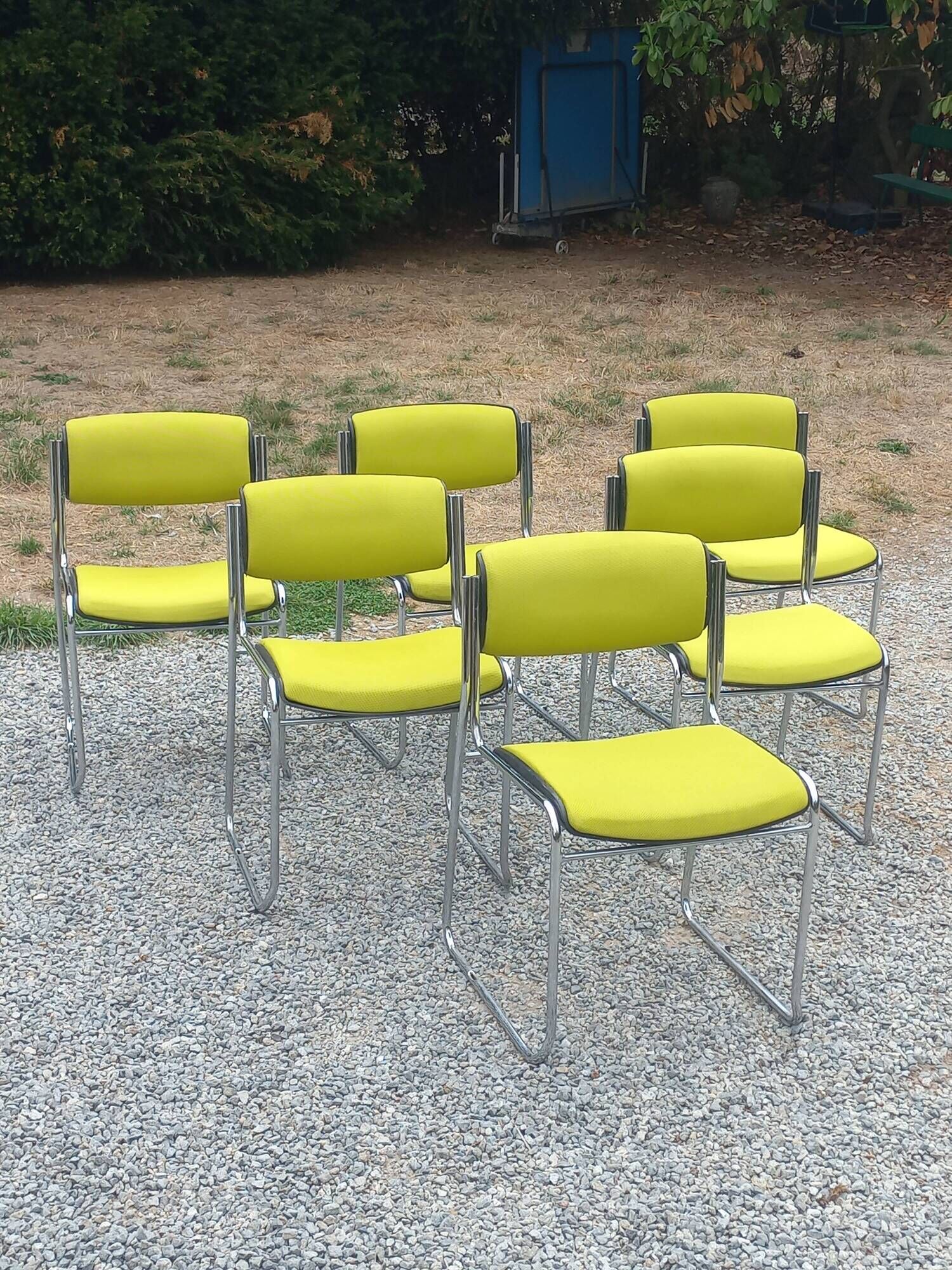 Set of 6 designer chairs with wooden seats and backs, chrome legs.