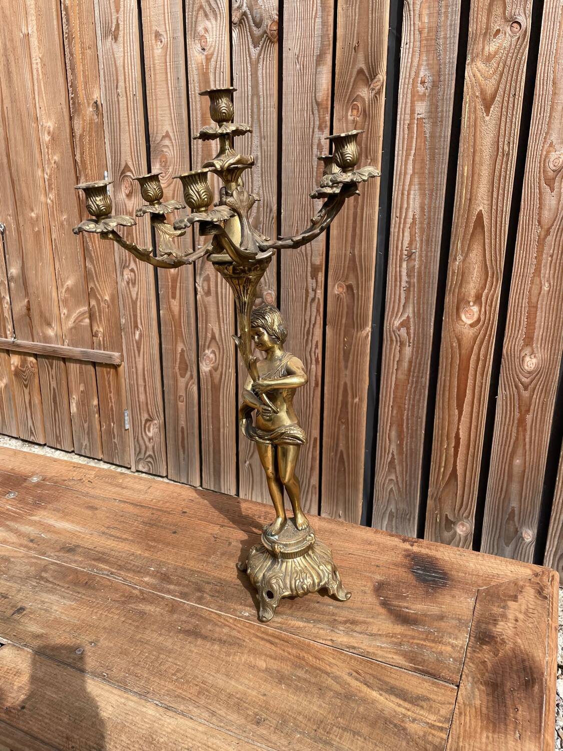 Large bronze candle holder with putti angel