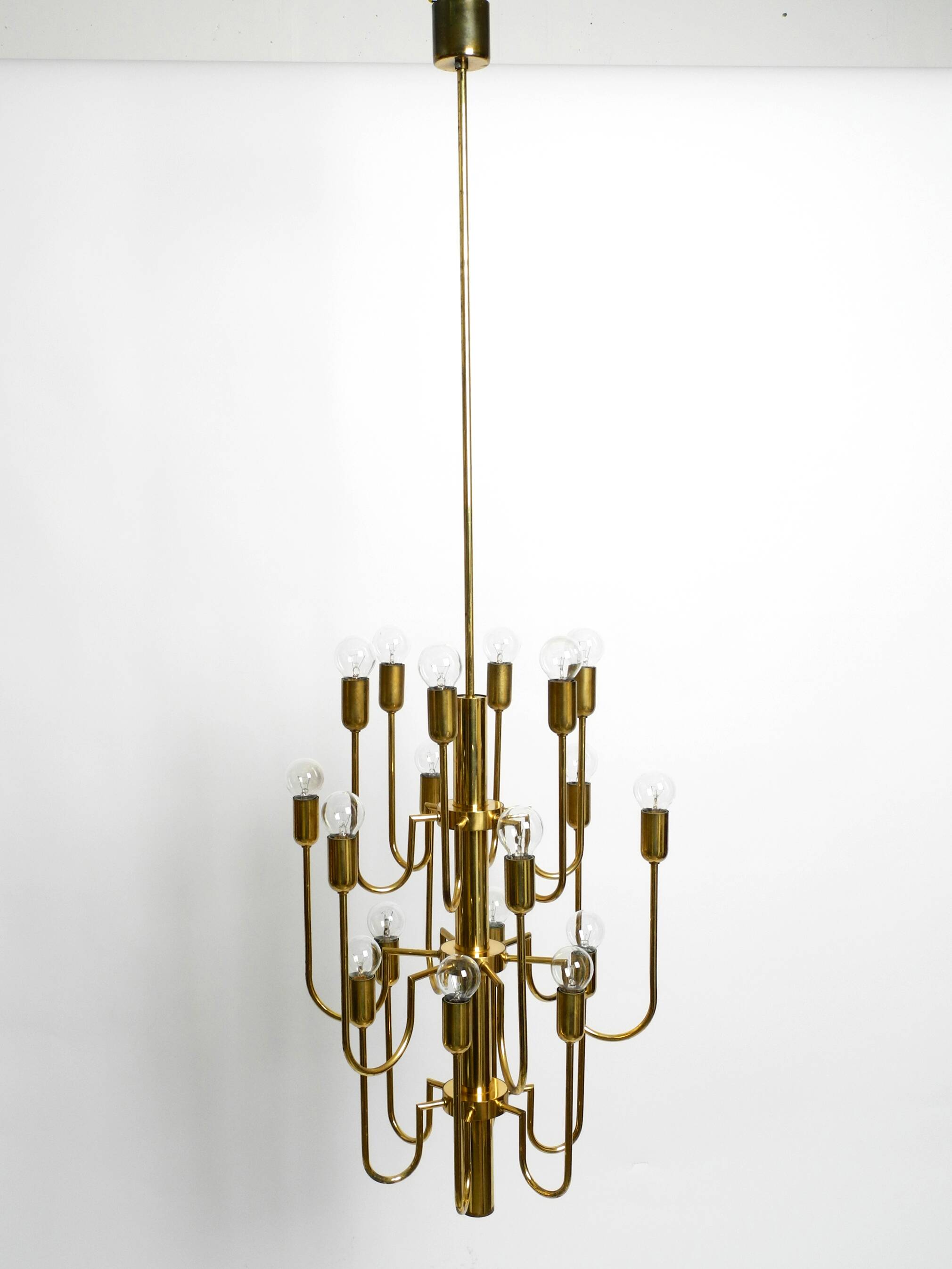 Three staged 18 arm Mid Century brass chandelier with a long brass rod