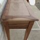 Console in solid walnut with a natural finish, featuring three drawers with a belt.