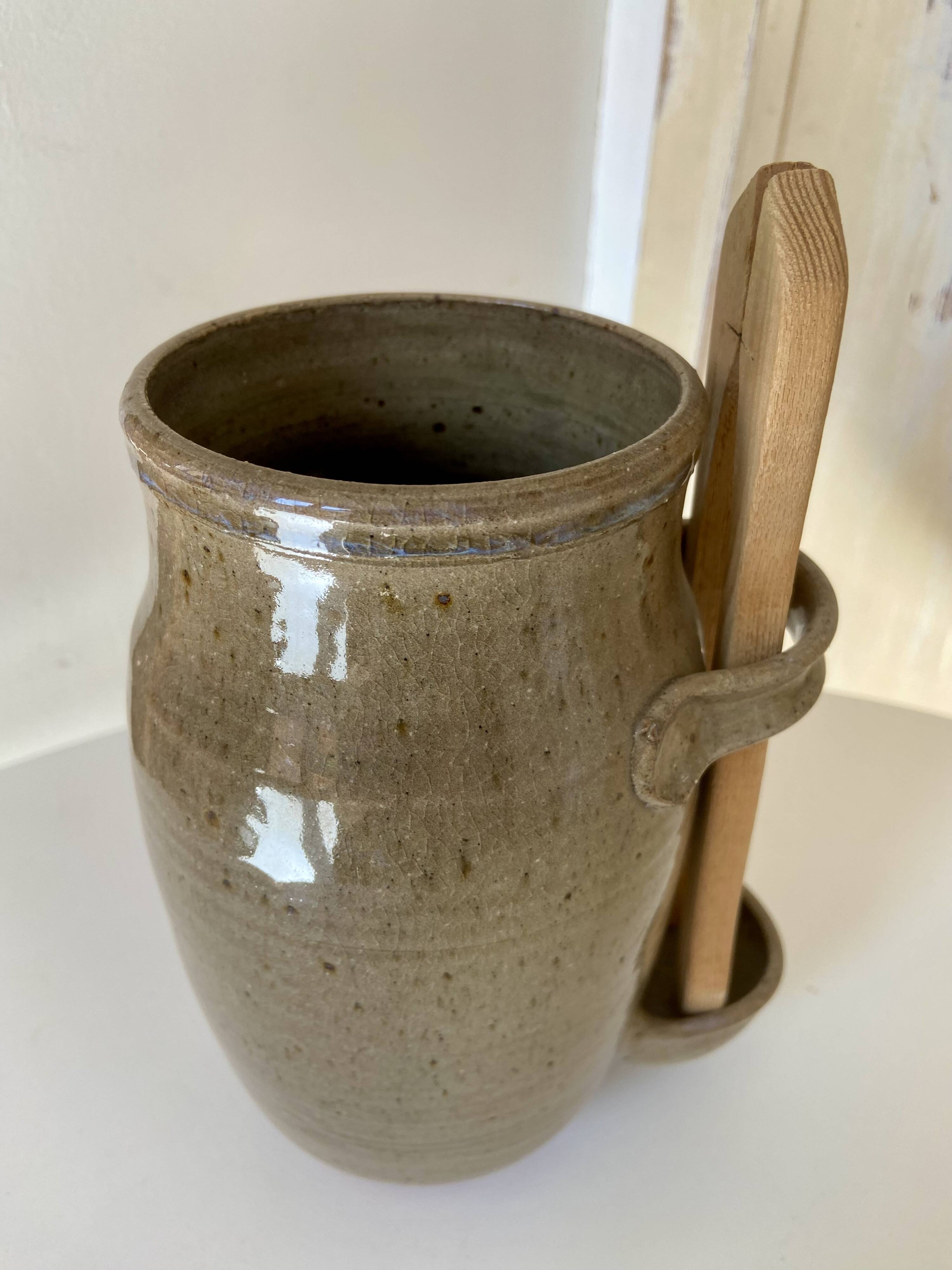 Old varnished stoneware pickle pot with tongs