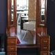Hairdresser with a large shaped mirror and two pivoting side mirrors.