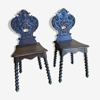 Duo of carved wooden chairs