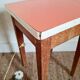 Wooden wax stool and orange formica
