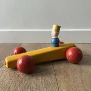 Vintage wooden pull toy, yellow car and small soldier.