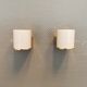 Wall lamps with milky white acrylic plastic shades and solid brass bases