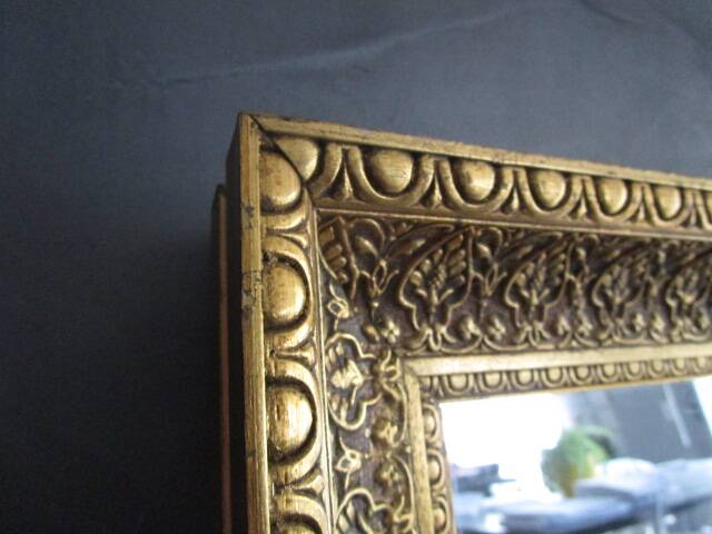 Large old mirror in wood and gilded stucco