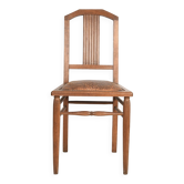 Art Deco style chair in carved wood and leather.