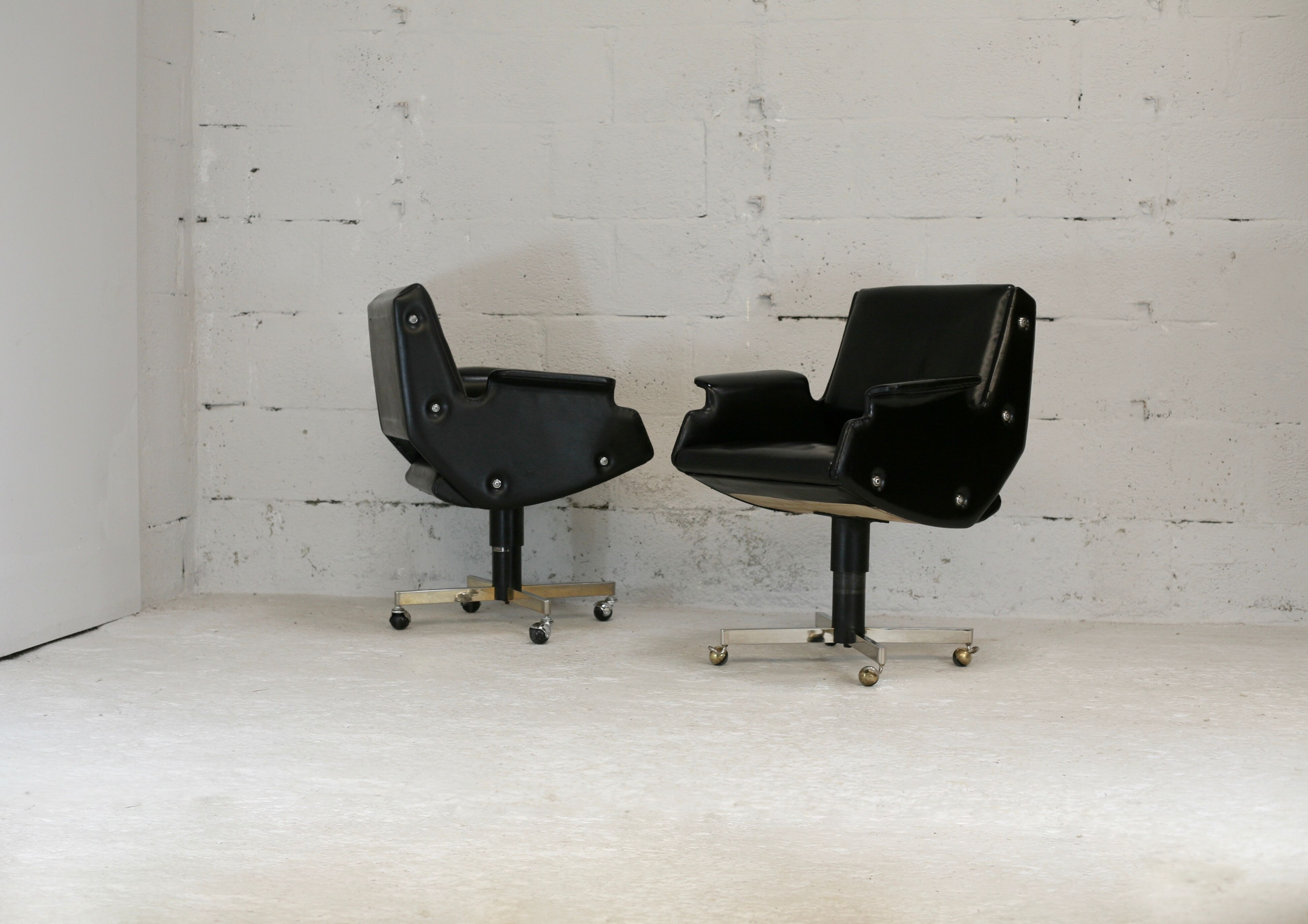 Pair of swivel armchairs, imitation leather and steel, Italy, circa 1960.
