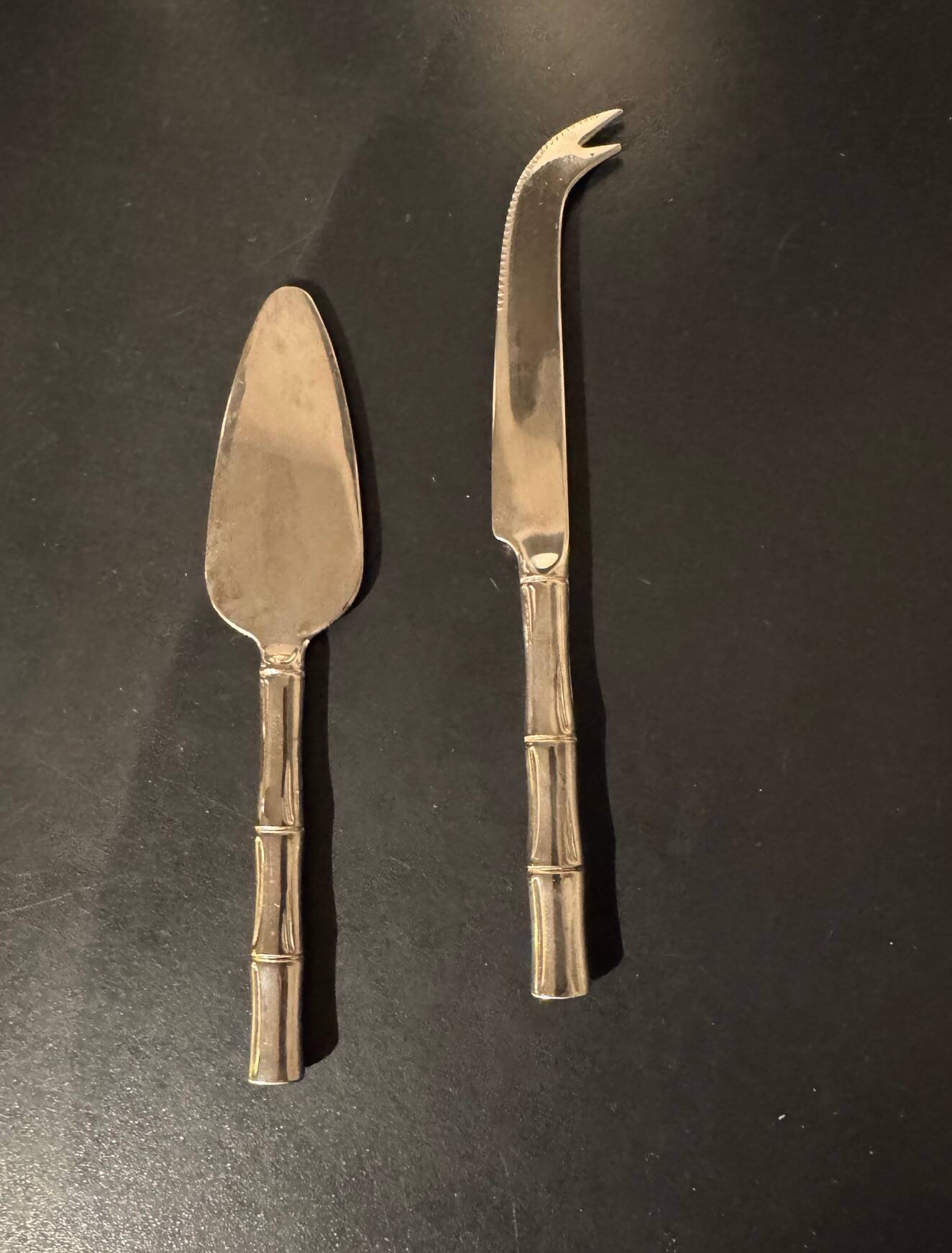 Golden metal cheese cutlery resembling bamboo