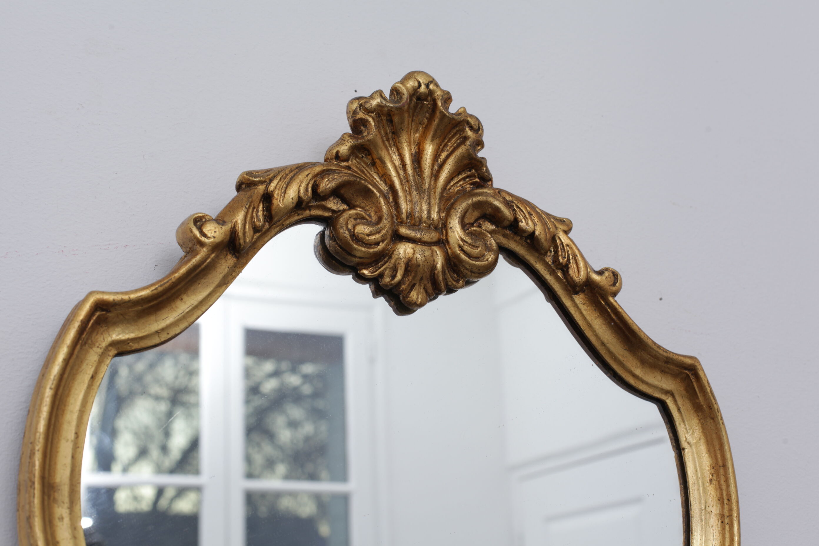 Golden rococo mirror with gold leaf