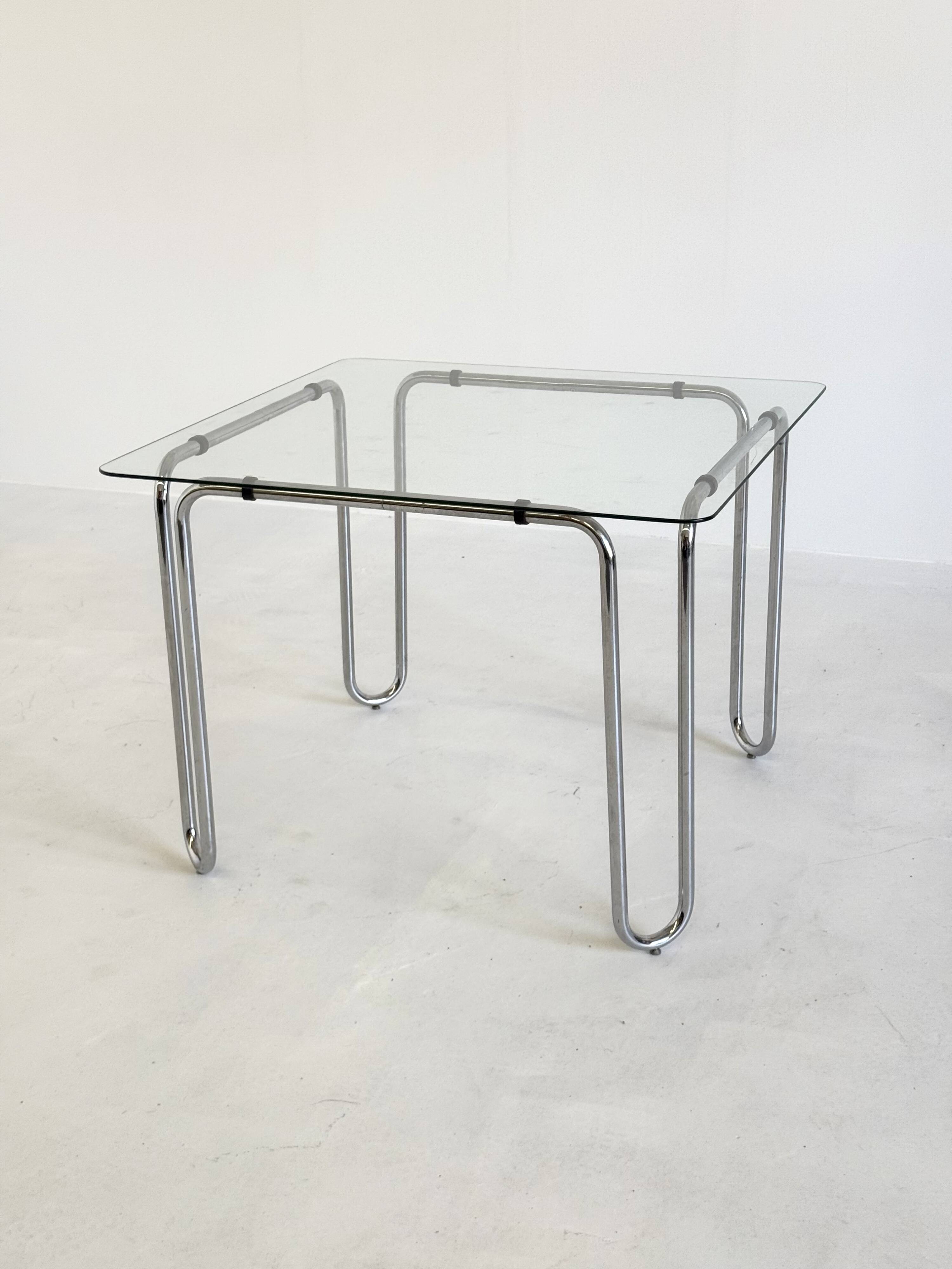 Italian vintage dining table with smooth glass and tubular frame base