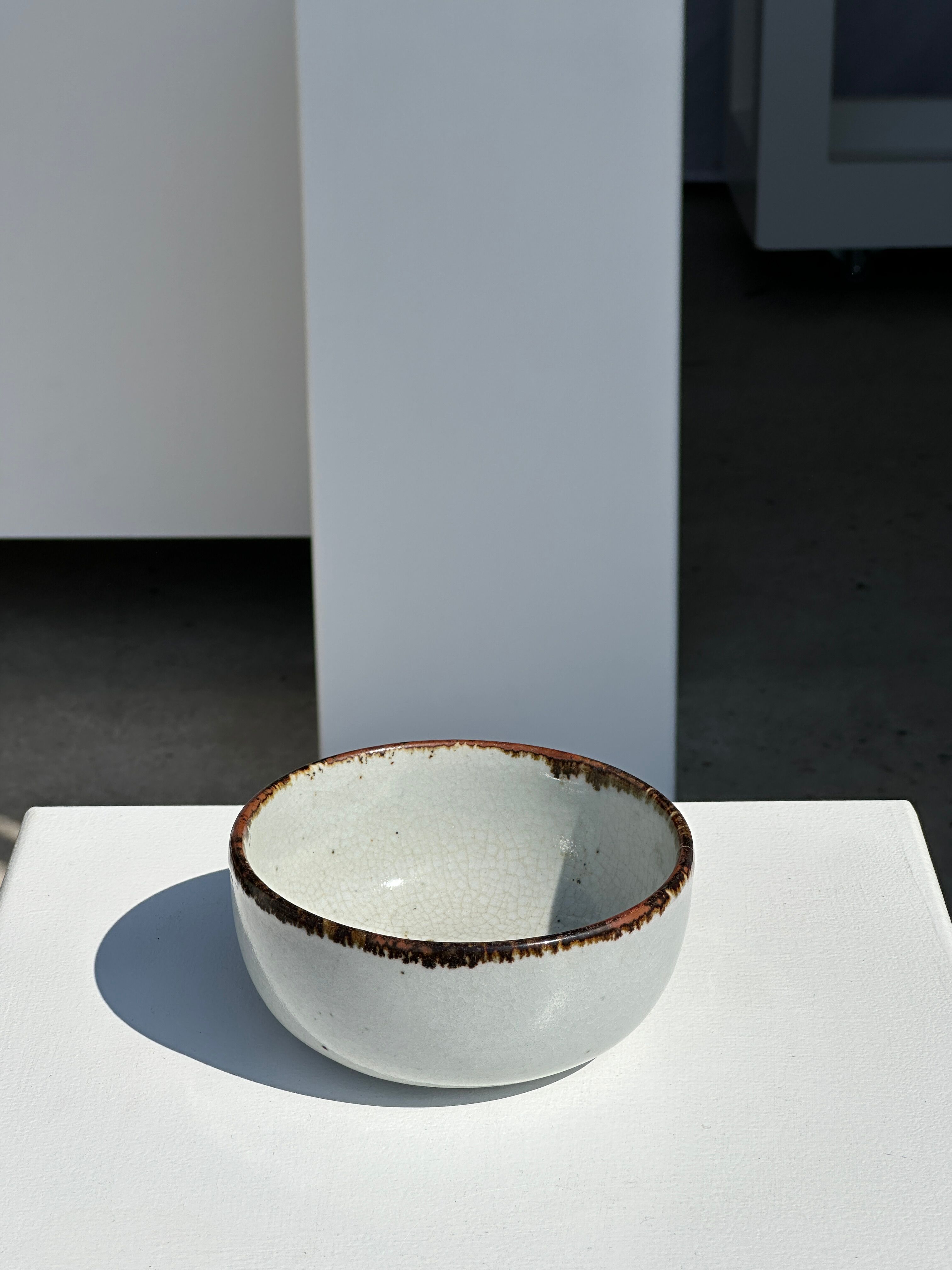 Small white glazed ceramic bowl black edges