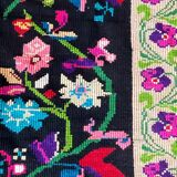 Romanian wool carpet floral design with green border on black background 180x153cm