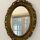 Old oval mirror in gilded resin