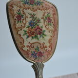 Antique hand mirror with stitched glass