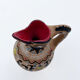 Clay pitcher with a bird head
