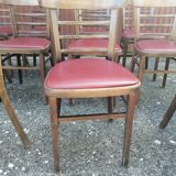 Set of 8 bistro chairs in vintage red wood and leatherette.