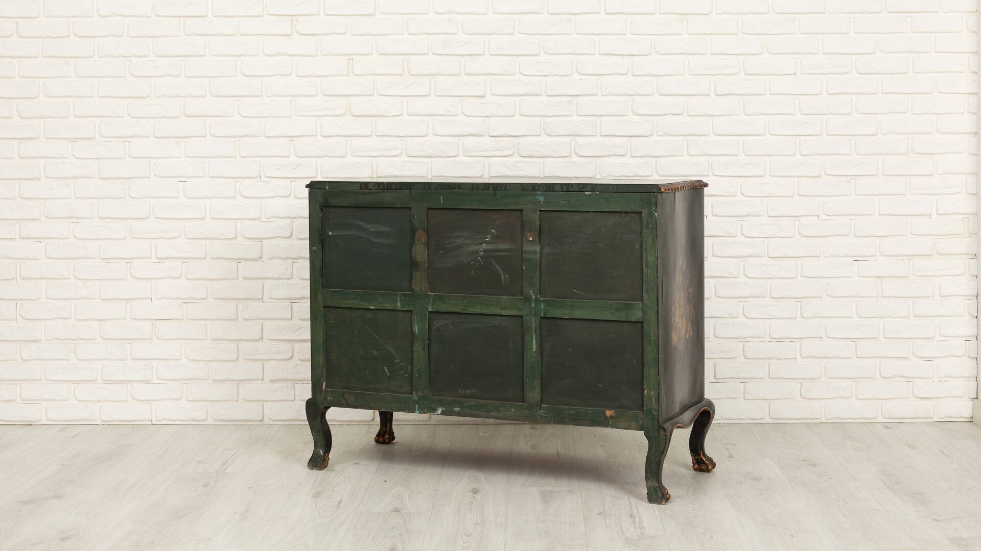 Green chest of drawers with floral decorations