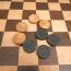 Old wooden checkers set and chessboard