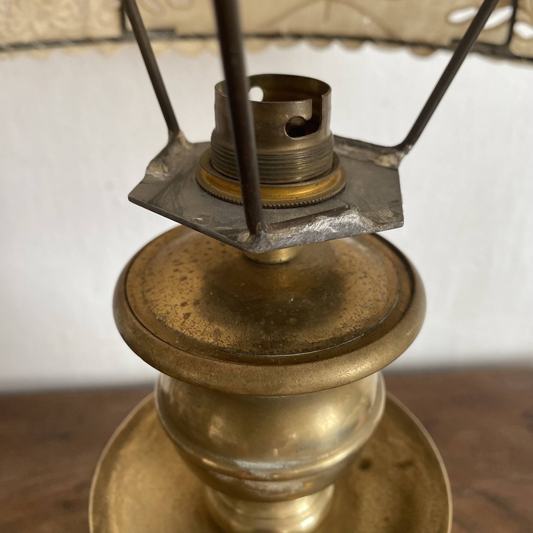 Antique brass lamp with embroidered openwork shade.
