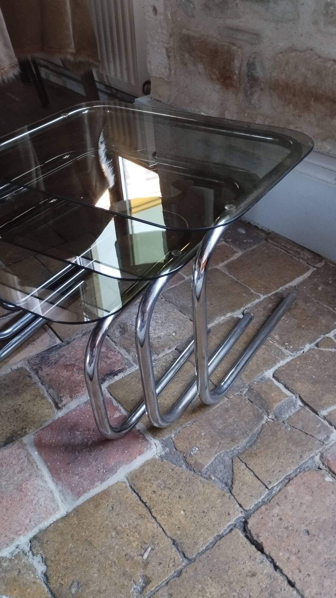 Nest of tables in glass and chrome steel.