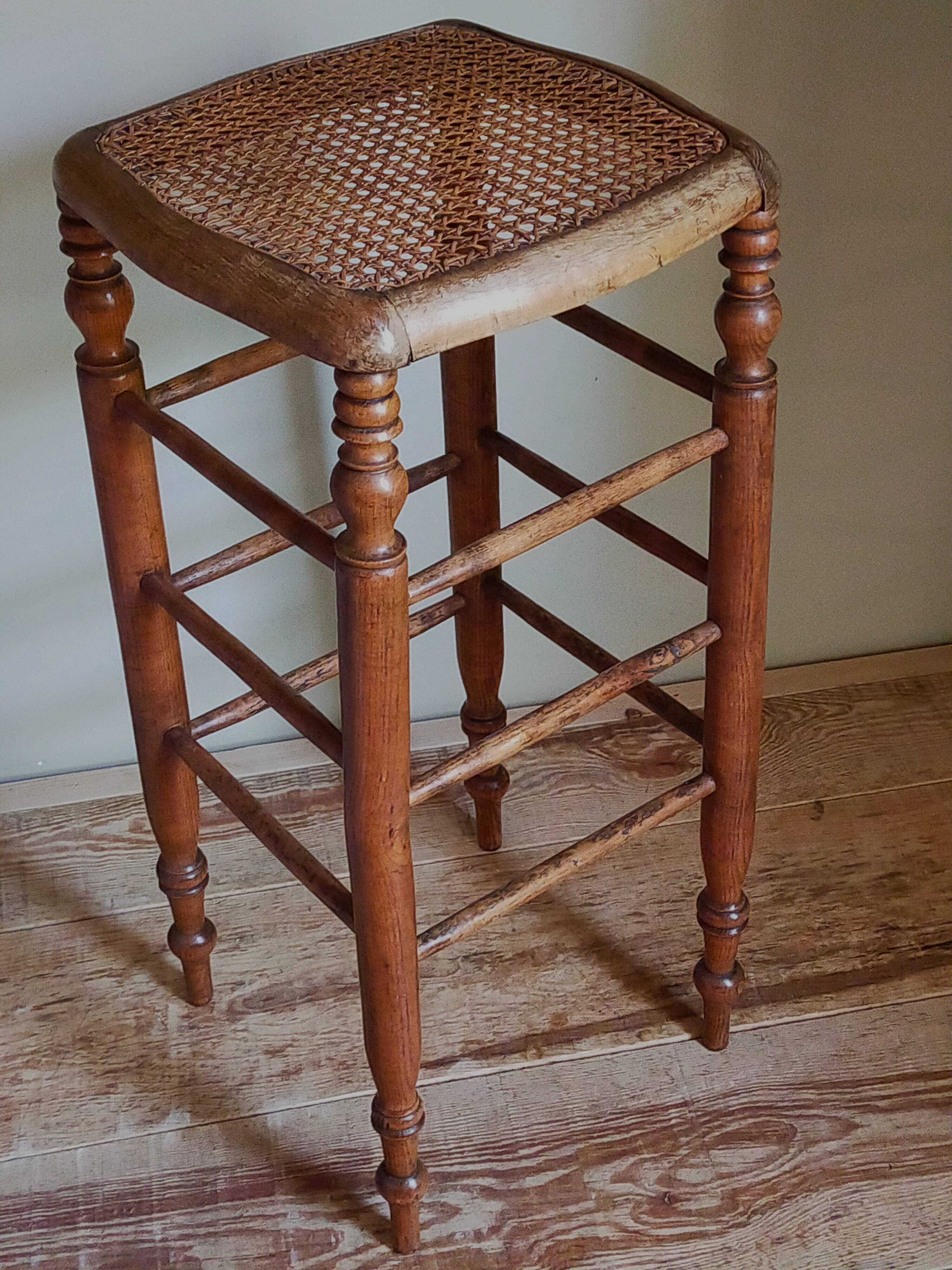 Antique stool with cane and turned wood