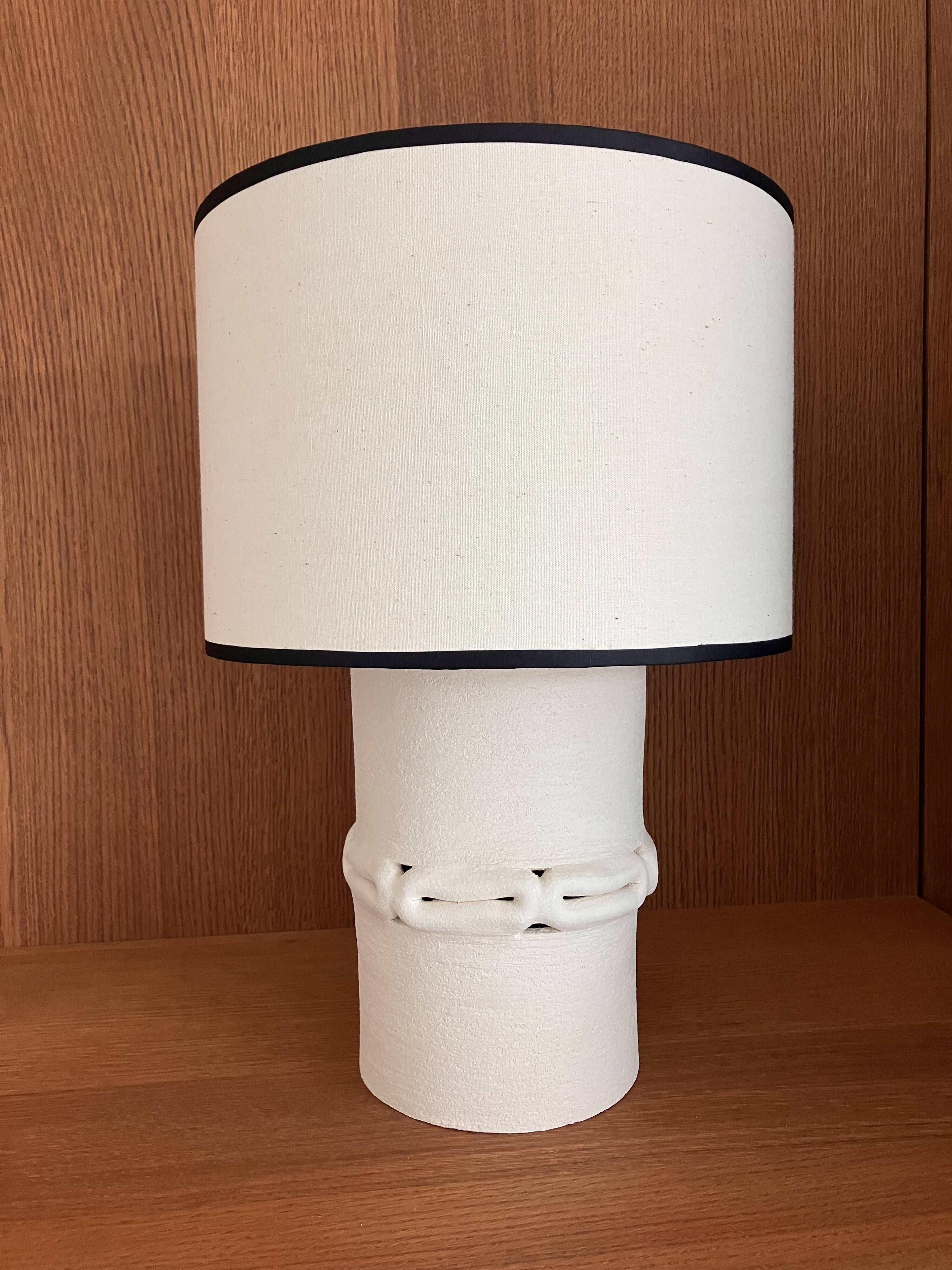 Table lamp in ceramic with a handmade couture-style lampshade from France.