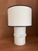 Table lamp in ceramic with a handmade couture-style lampshade from France.