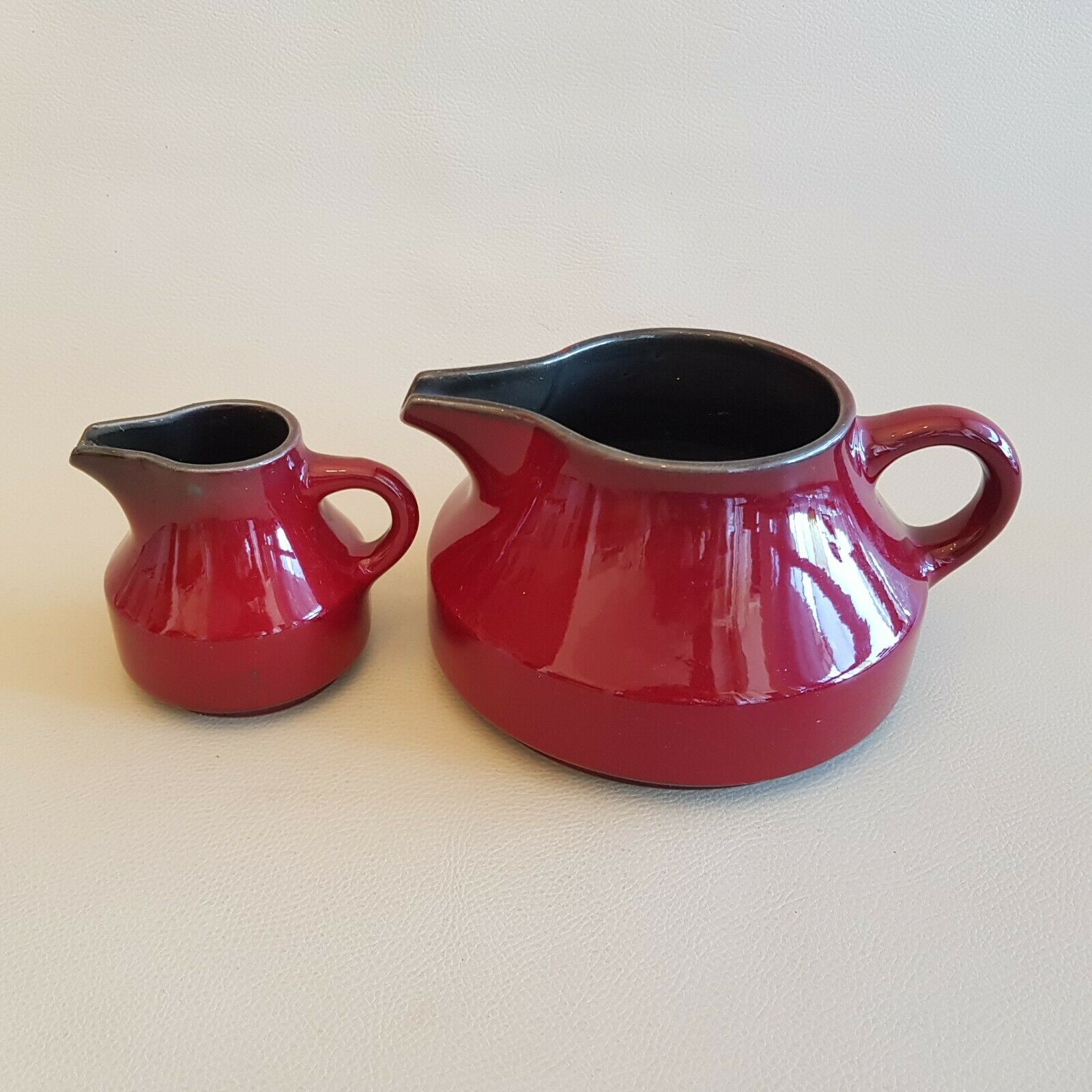 Teapot and milk jar in burgundy red ceramic