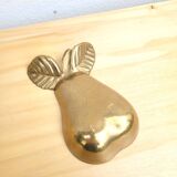 Pear-shaped pocket emptier in gilded brass