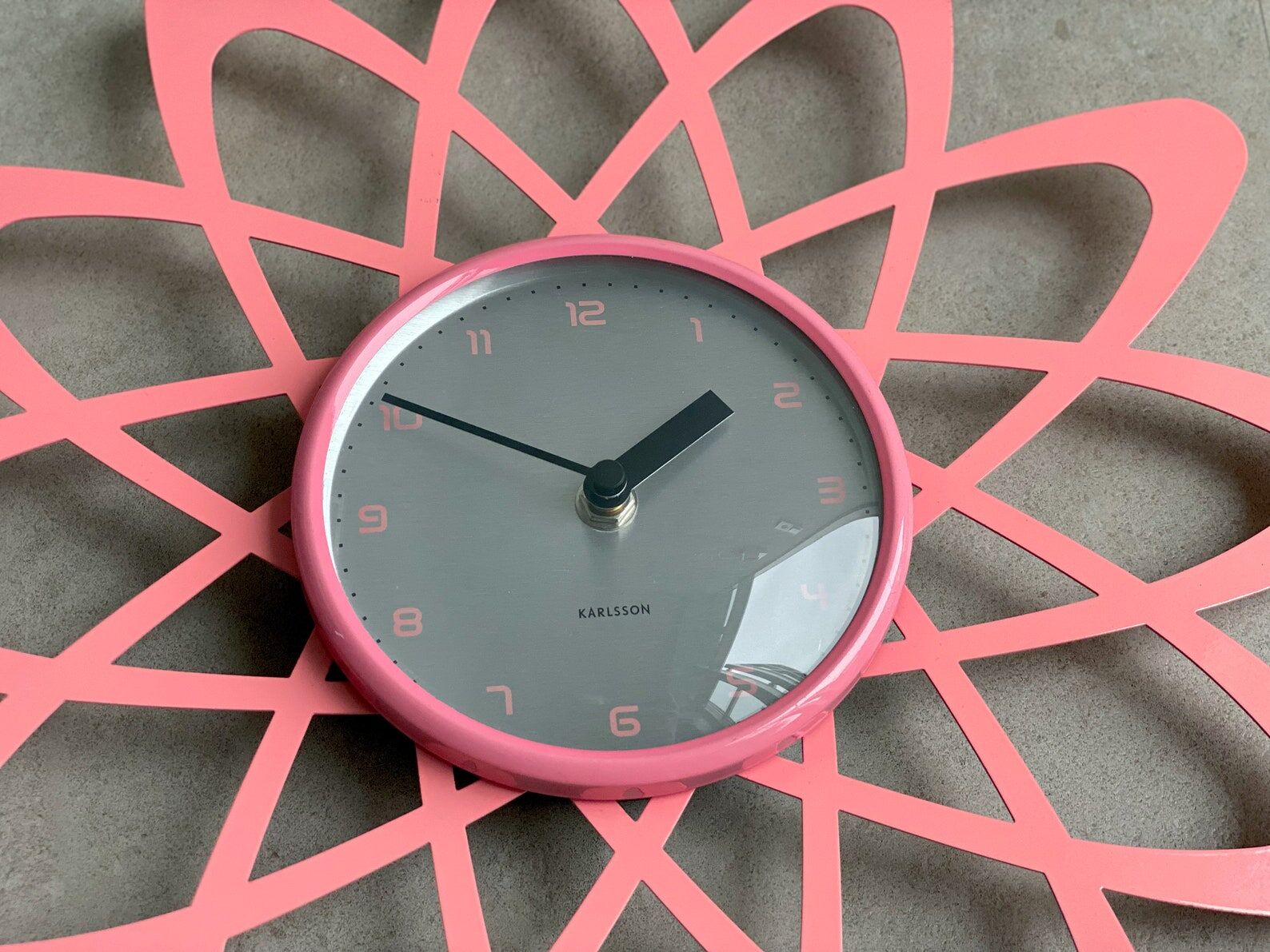 Pink Karlsson wall clock in a mid century shape