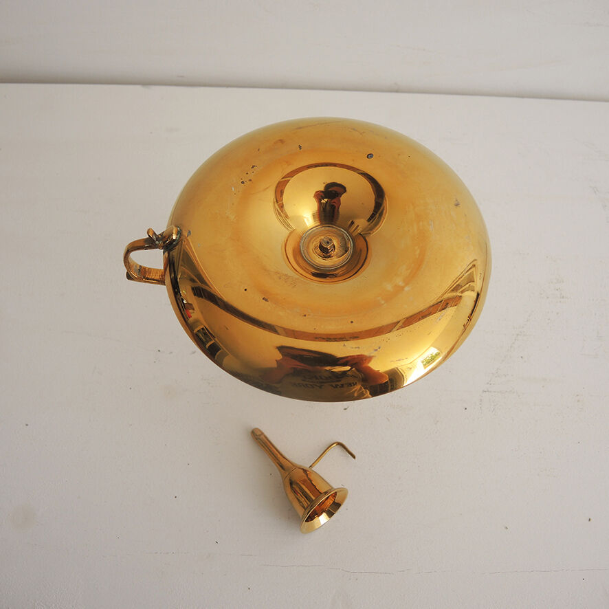 Old candlestick with brass extinguisher.