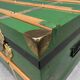 Green metal trunk with wooden sleds