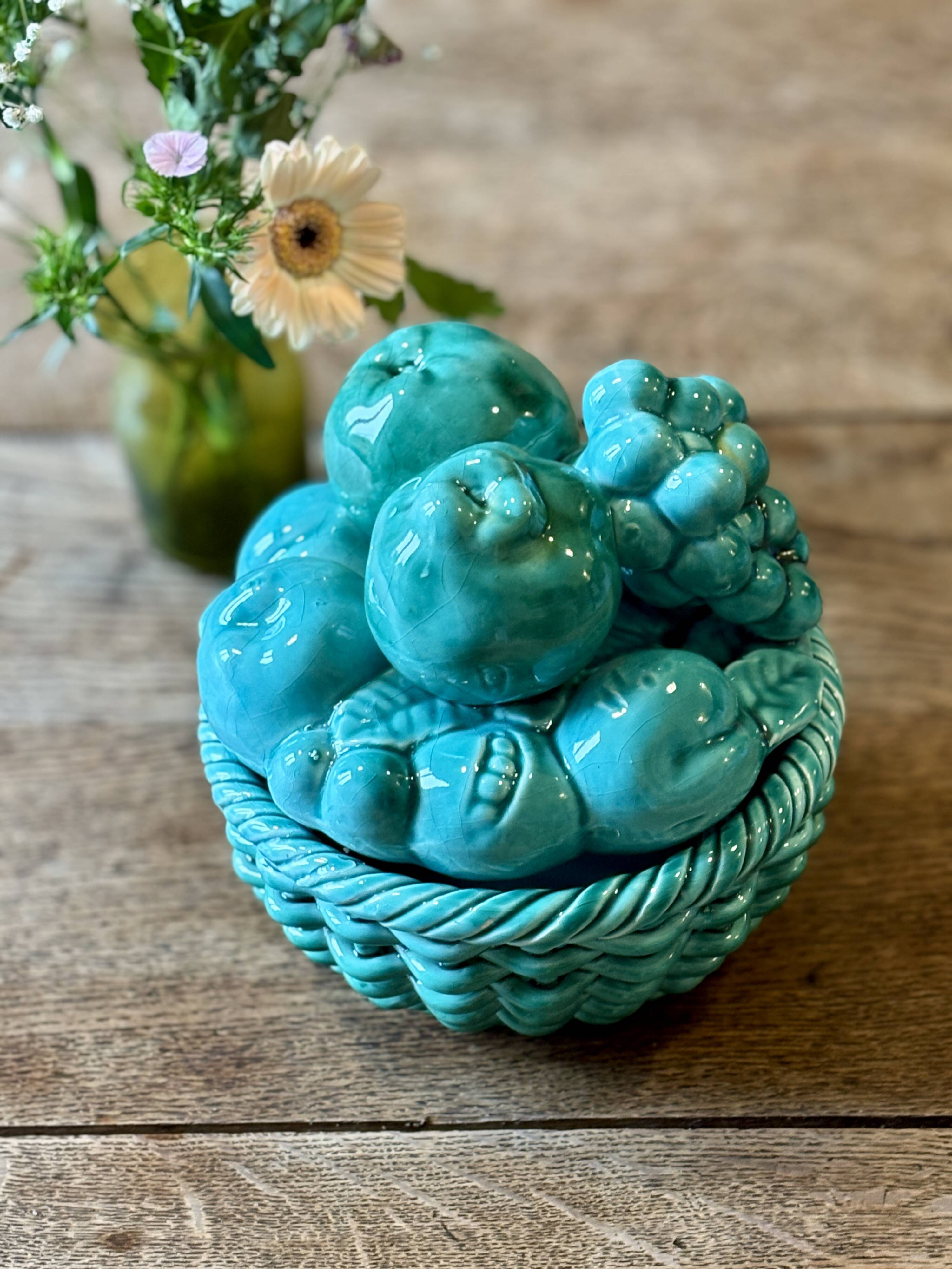 Vintage green earthenware plate/basket with fruit decorations.