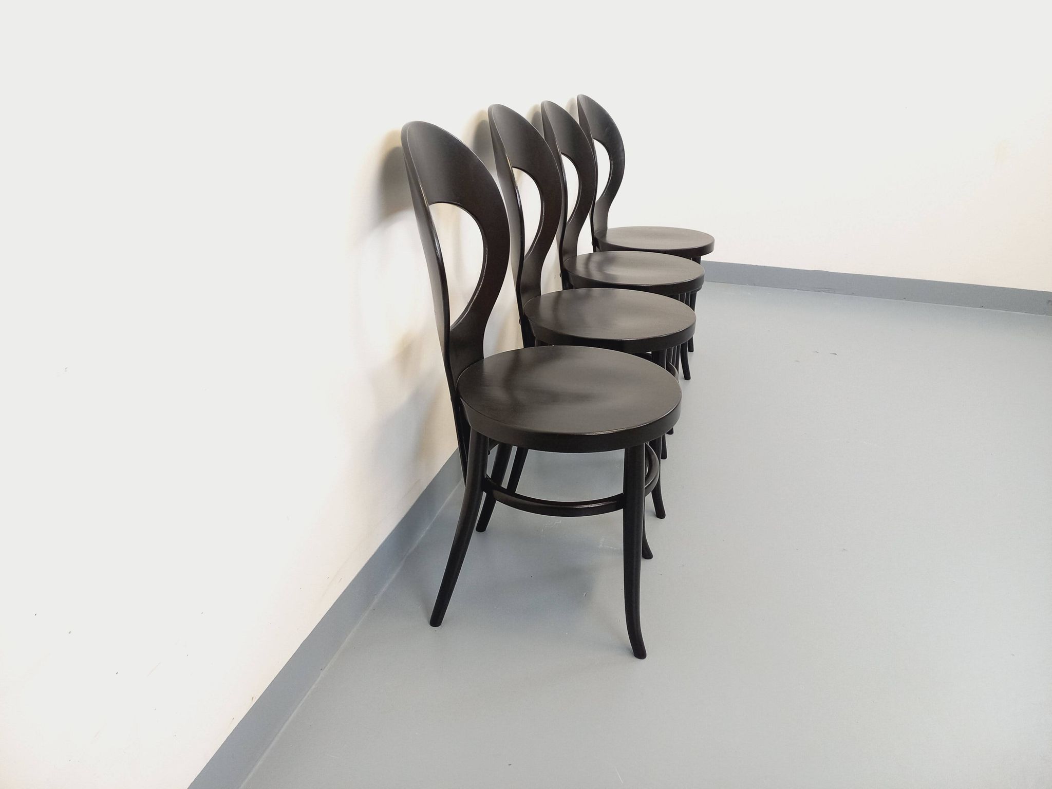 Set of 4 vintage Mouette chairs by Baumann in black wood from the 1960s.