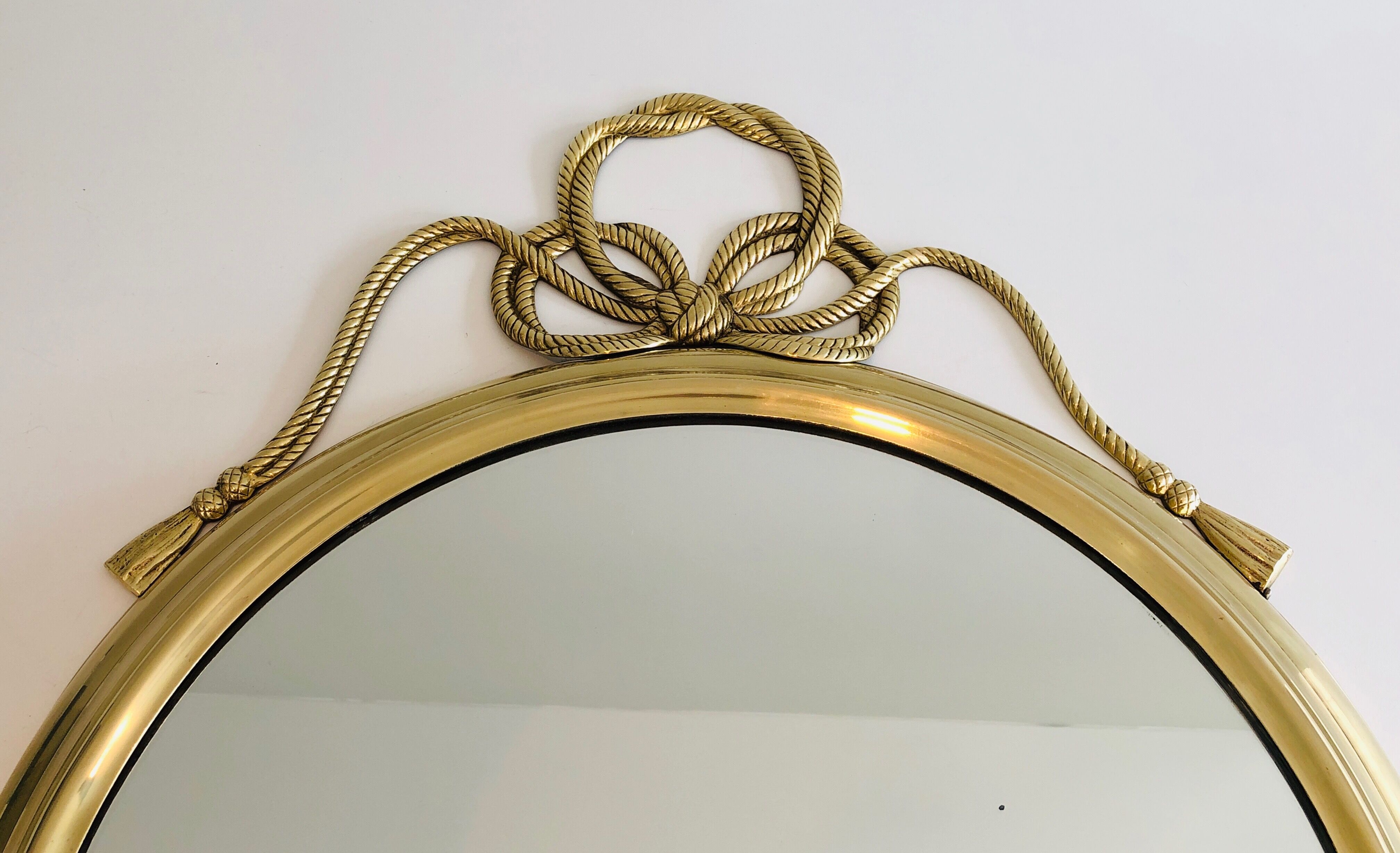 Oval Decorative Mirror in Brass decorated with an Important Twisted Knot