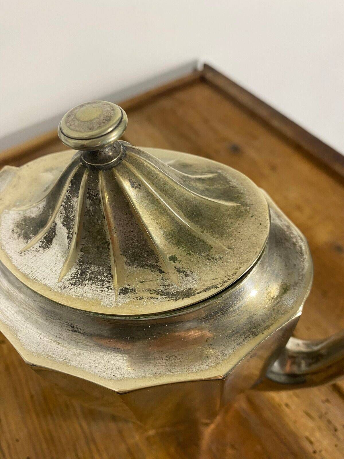Art Deco silver-plated teapot with faceted decoration.