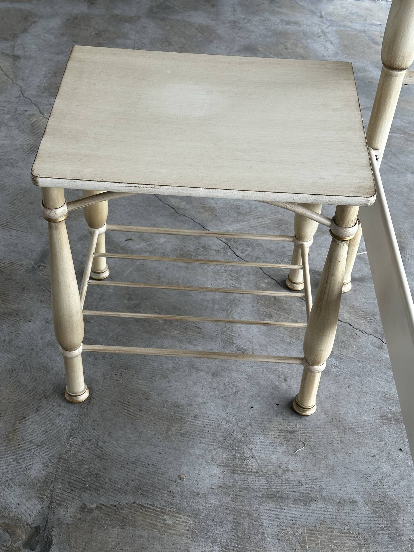 Patinated metal and wood double bed with integrated bedside tables.